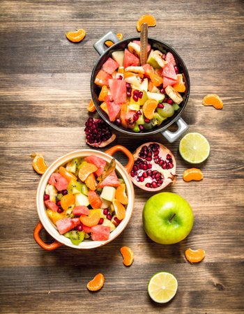 Tropical food. Fresh salad of exotic fruits. On a wooden table.の写真素材