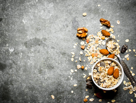 Fitness food. Cereals with dried fruit in the Cup. On the stone table.の写真素材