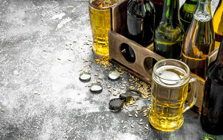 Beer background. Fresh beer in glasses and an old box. On a rustic backgroundの写真素材