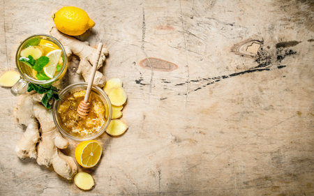 Ginger tea with mint and lemon. On wooden background.の写真素材