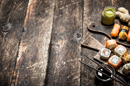Japanese food. The sushi rolls and fresh seafood. On the old wooden background.の写真素材