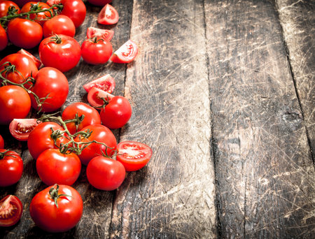 Fresh ripe tomatoes. On the wooden backgroundの写真素材