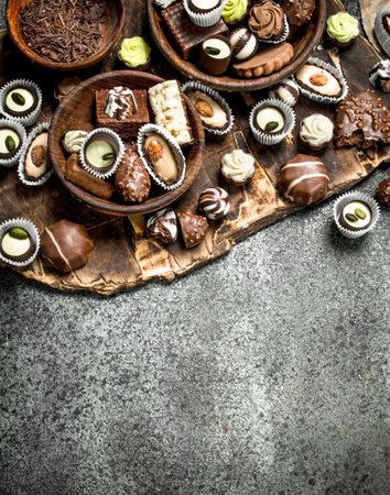 Chocolate candies in a bowls. On a rustic background.の写真素材