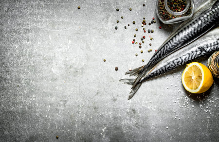 Fresh fish with spices and lemon. On the stone table.の写真素材