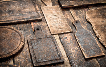 Serving background. Different old cutting Board. On a wooden table.