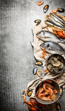 Fresh seafood. Fresh shrimp, fish and shellfish. On a stone background.の写真素材