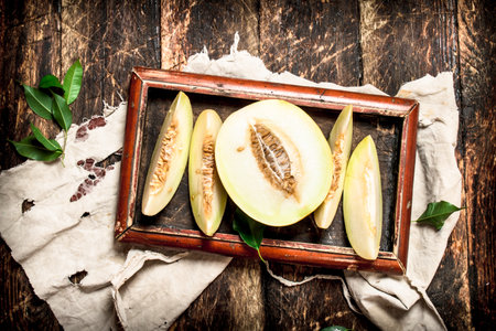 Sliced fresh melon. On the wooden background.の写真素材
