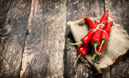 Hot chili peppers. On a wooden background.の写真素材