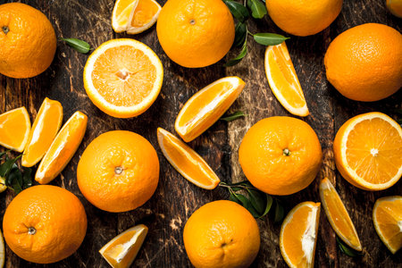 Fresh oranges with leaves. On a wooden background.の写真素材