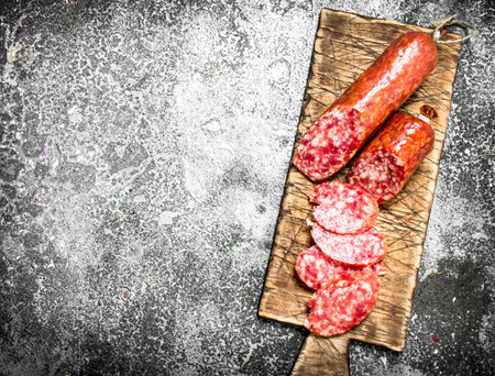 Salami with spices and herbs. On a rustic background.の写真素材