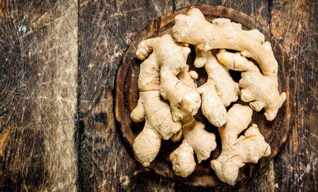 Fresh ginger. On the wooden background