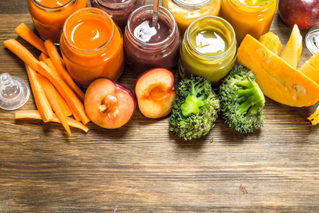 Baby food. Various purees of fruits and vegetables. On a wooden background.の写真素材