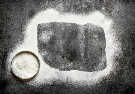 Baking background. The frame is made from flour with a sieve.の写真素材