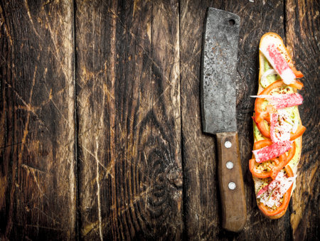 sandwich with tomatoes, crab meat and spicy sauce on a fresh bun. On a wooden background.の写真素材