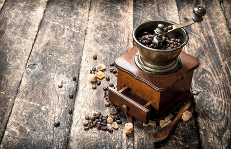 Coffee grinder with coffee beans. On a wooden background.の写真素材
