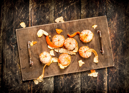 Ripe peeled mandarin. On a wooden background.の写真素材
