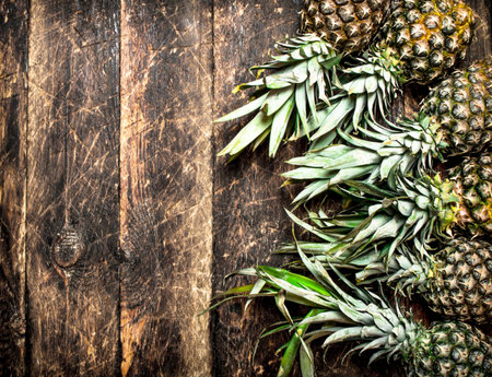 Ripe pineapples. On wooden background. Top viewの写真素材