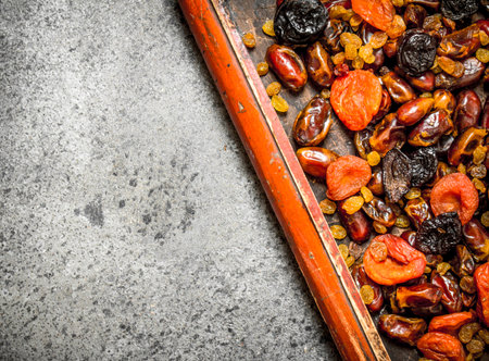Various dried fruits in tray. On rustic background .の写真素材