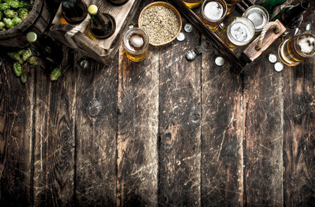 Fresh beer with green hops and malt. On a wooden background.の写真素材