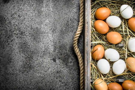 Fresh chicken eggs on an old tray. On a rustic background.の写真素材