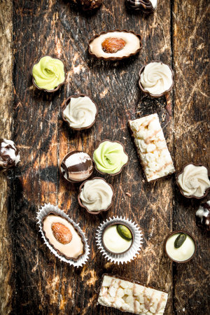 Chocolate sweet candies. On a wooden background.の写真素材