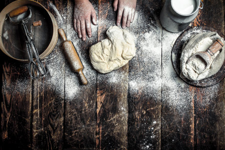 Dough background. Preparation of the dough with the ingredients. On the wooden table.の写真素材