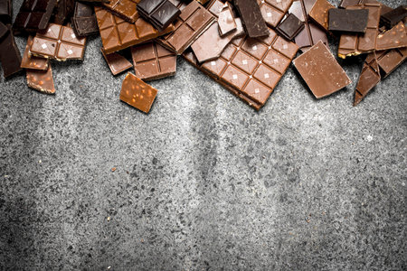 Broken chocolate bars. On a rustic background.の写真素材