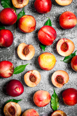Fresh peaches with green leaves. On rustic background.の写真素材