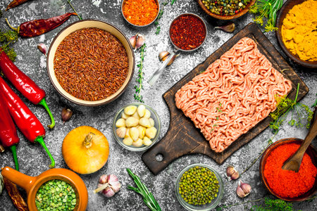 Beef minced meat with aromatic spices and herbs. On a rustic background.の写真素材