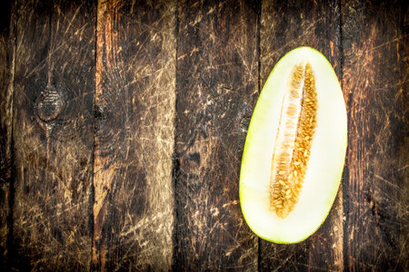 Ripe fresh melon. On a wooden backgroundの写真素材