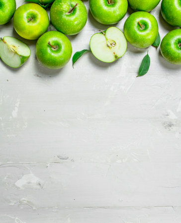 green fresh apples. On white rustic background.の写真素材