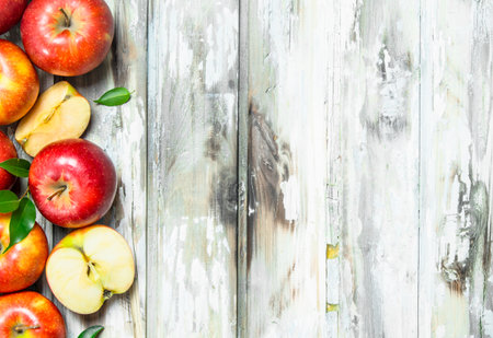 Red apples and Apple slices. On a white wooden background.の写真素材