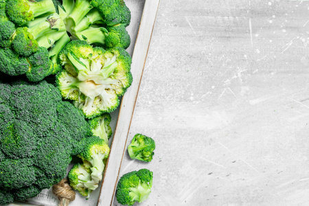 Broccoli on tray. On rustic backgroundの写真素材