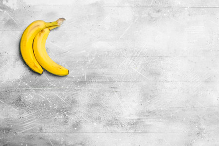 The smell of fresh bananas. On white rustic background.の写真素材