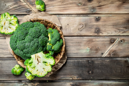 Ripe broccoli in the basket. On a wooden background.の写真素材