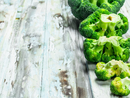Lots of fresh broccoli. On a wooden background.の写真素材