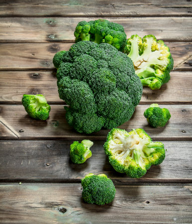 Pieces of fresh broccoli. On a wooden background.の写真素材
