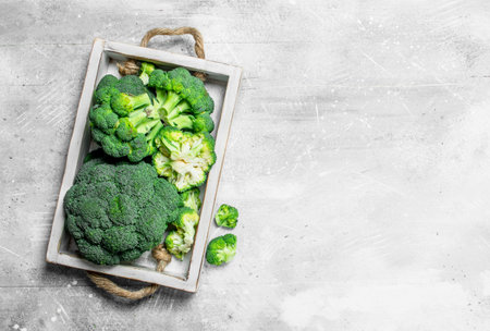 Broccoli on tray. On rustic backgroundの写真素材