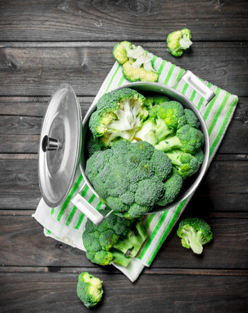 Broccoli in pot. On a wooden background.の写真素材