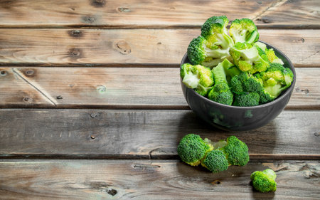 broccoli in a bowl. On a wooden background.の写真素材