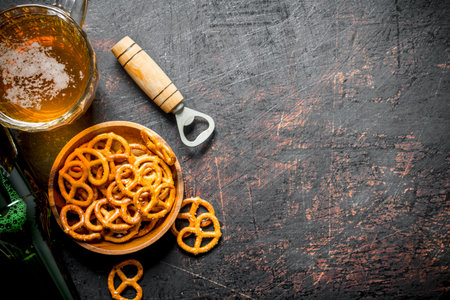 Beer with snacks in the bowl. On rustic backgroundの写真素材