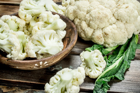 Cabbage in a wooden bowl. On a wooden background.の写真素材
