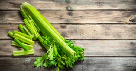 Fresh juicy celery. On wooden backgroundの写真素材