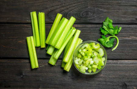 Fresh juicy celery in a bowl. On wooden backgroundの写真素材