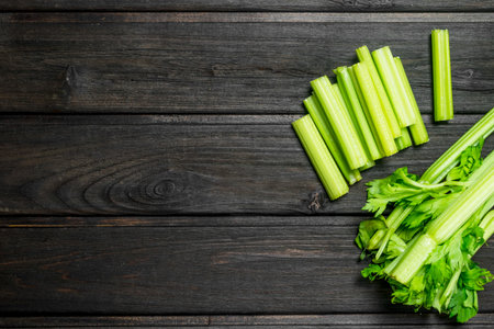 Pieces of fresh celery. On wooden backgroundの写真素材