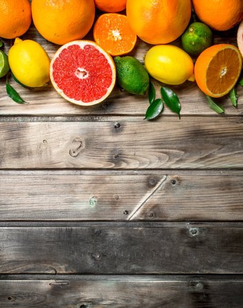 Ripe juicy citrus with leaves. On wooden backgroundの写真素材