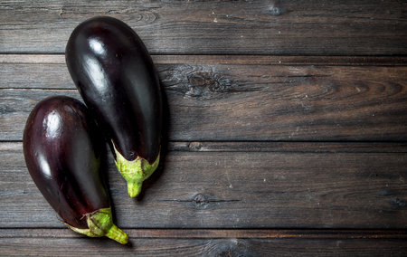 Fresh ripe eggplant. On black wooden backgroundの写真素材