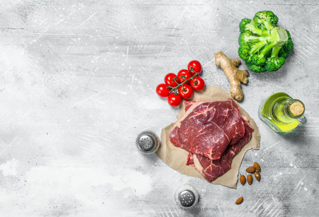 organic food. Raw beef meat with healthy food. On a rustic background.の写真素材