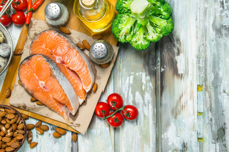Health food. Salmon with honey, nuts and vegetables. On a rustic background.の写真素材