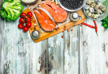 Health food. Salmon steaks with organic food. On a rustic background.の写真素材